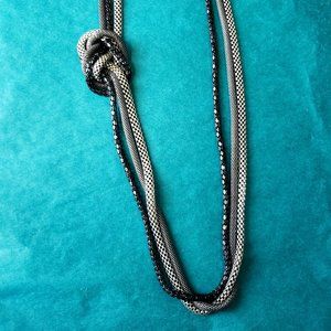 2/10$ Black and silver toned knotted necklace